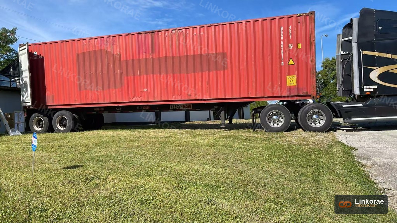 A 40-ft high-cube container on a chassis, marked CAUTION 9 ft 6 in HIGH