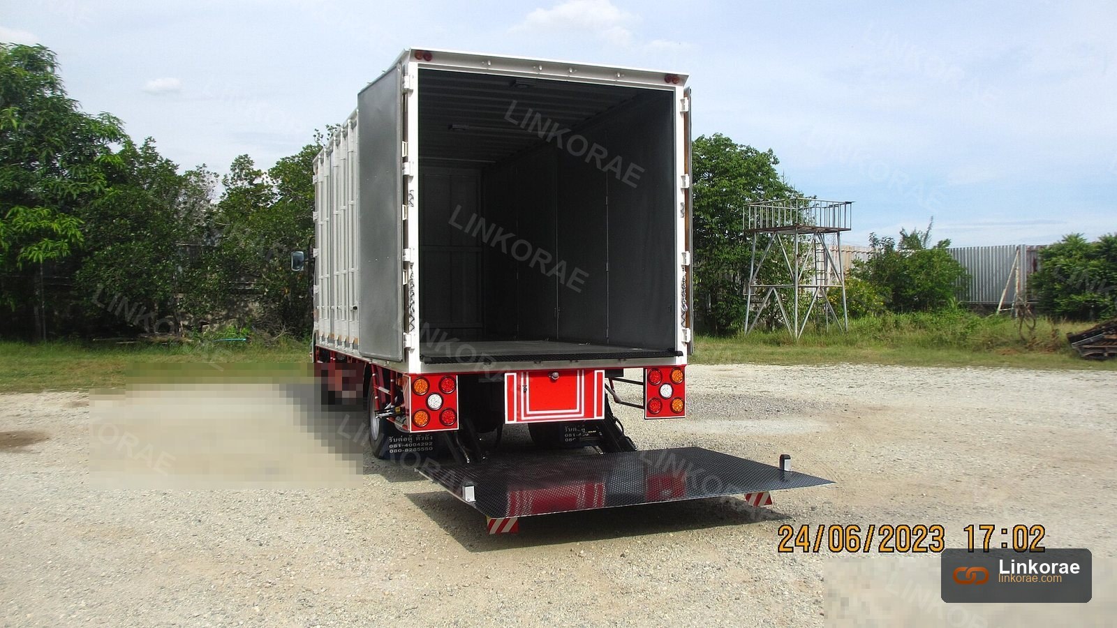 Box truck with the hydraulic liftgate lowered to the ground