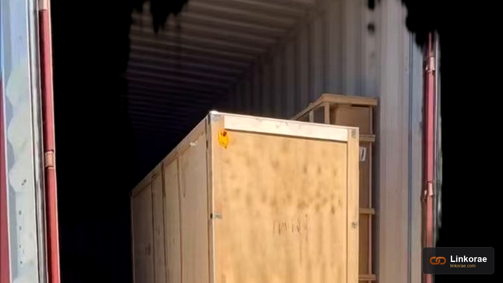 A wooden crate still inside an open container — delivery to the address is not the same as unloading